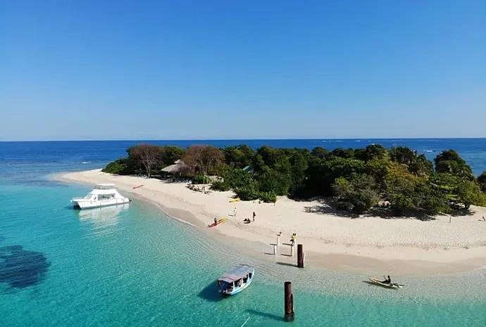 Island beach with boats on the northern Haiti coastline