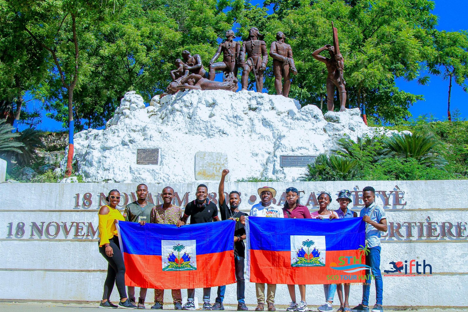 Travelers with Haitian flags at the Vertières monument